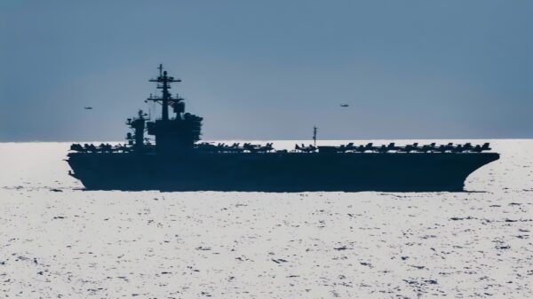 ATLANTIC OCEAN (Aug. 30, 2018) An MH-60S Sea Hawk helicopter assigned to Carrier Air Wing (CVW) 7 flies by the Nimitz-class aircraft carrier USS Abraham Lincoln (CVN 72) during dual-carrier sustainment operations with the Nimitz-class aircraft carrier USS Harry S. Truman (CVN 75). In addition to demonstrating the Navy's inherent flexibility and scalability, this evolution provides the opportunity to conduct complex, multi-unit training to enhance maritime interoperability and combat readiness; prepare the Navy to protect our homeland; and preserve and promote peace anywhere around the world. (U.S. Navy photo by Mass Communication Specialist 3rd Class Juan Sotolongo/Released)