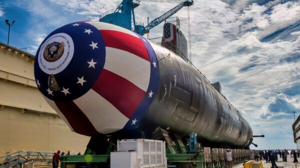 The Virginia-class attack submarine Pre-commissioning Unit (PCU) John Warner (SSN 785) is moved to Newport News Shipbuilding's floating dry dock in preparation for the Sept. 6 christening. A team of shipbuilders spent about eight hours to move the submarine from the facility where it was assembled to the dock. (U.S. Navy photo courtesy of Huntington Ingalls Industries by John Whalen/Released)