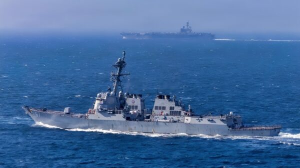 The Arleigh Burke-class guided-missile destroyer USS Mason (DDG 87) transits alongside the Nimitz-class aircraft carrier USS George H.W. Bush in the Atlantic Ocean, Feb. 21, 2026. The George H.W. Bush Carrier Strike Group is at sea training as an integrated warfighting team. Composite Training Unit Exercise (COMPTUEX) is the Joint Force’s most complex integrated training event and prepares naval task forces for sustained high-end Joint and combined combat. Integrated naval training provides combatant commanders and America’s civilian leaders highly capable forces that deter adversaries, underpin American security and economic prosperity, and reassure Allies and partners. (U.S. Navy photo by Mass Communication Specialist 2nd Class Jayden Brown)