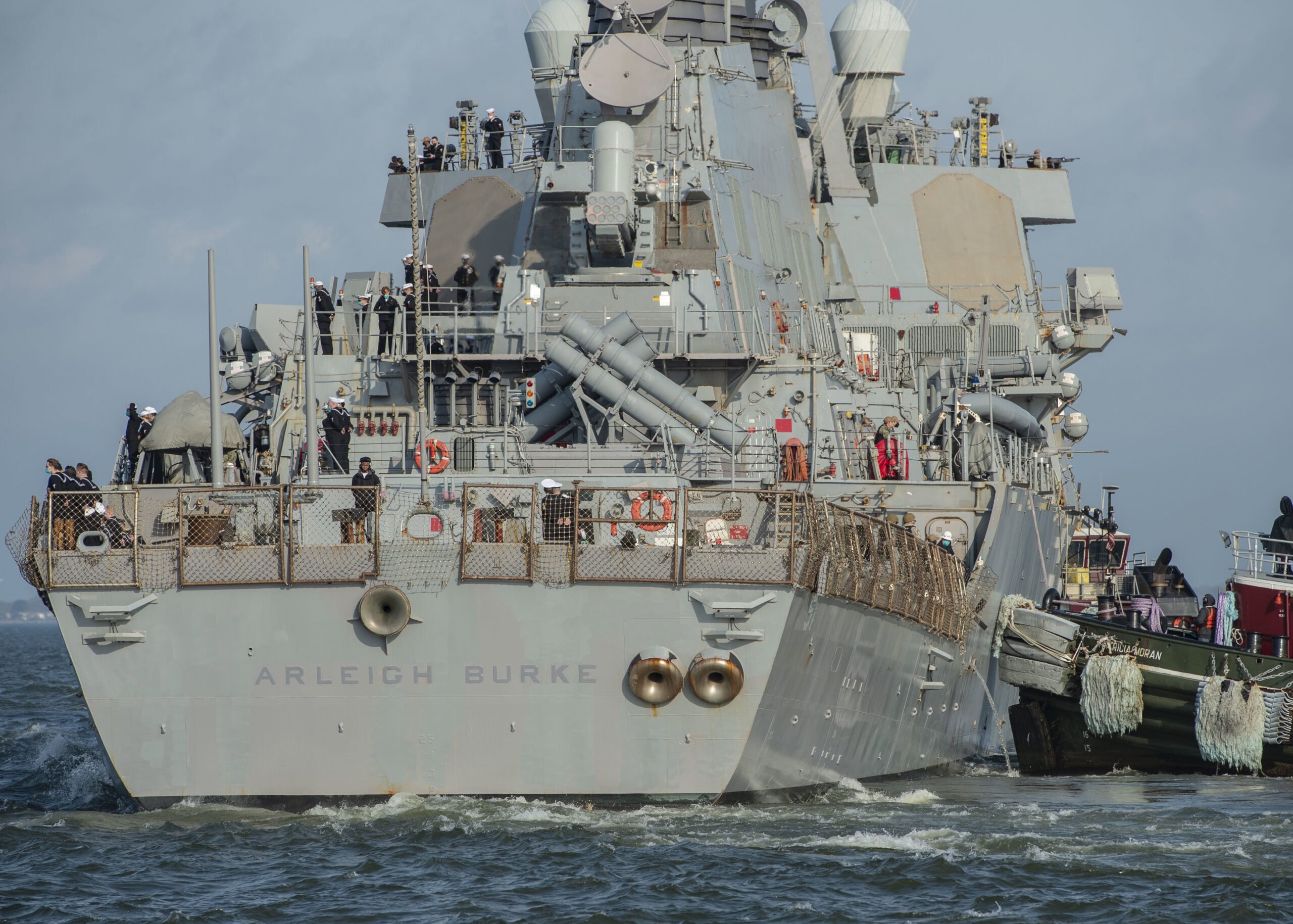 NORFOLK (Mar. 26, 2021) – A tugboat assists the guided-missile destroyer USS Arleigh Burke (DDG 51) in getting underway Mar. 26. Arleigh Burke will replace USS Donald Cook (DDG 75) as one of four forward deployed naval forces (FDNF) located in Spain. Arleigh Burke will join USS Ross (DDG 71), USS Roosevelt (DDG 80), and USS Porter (DDG 78) as the newest member of FDNF Rota. (U.S. Navy photo by Mass Communication Specialist 2nd Class Kris R. Lindstrom)