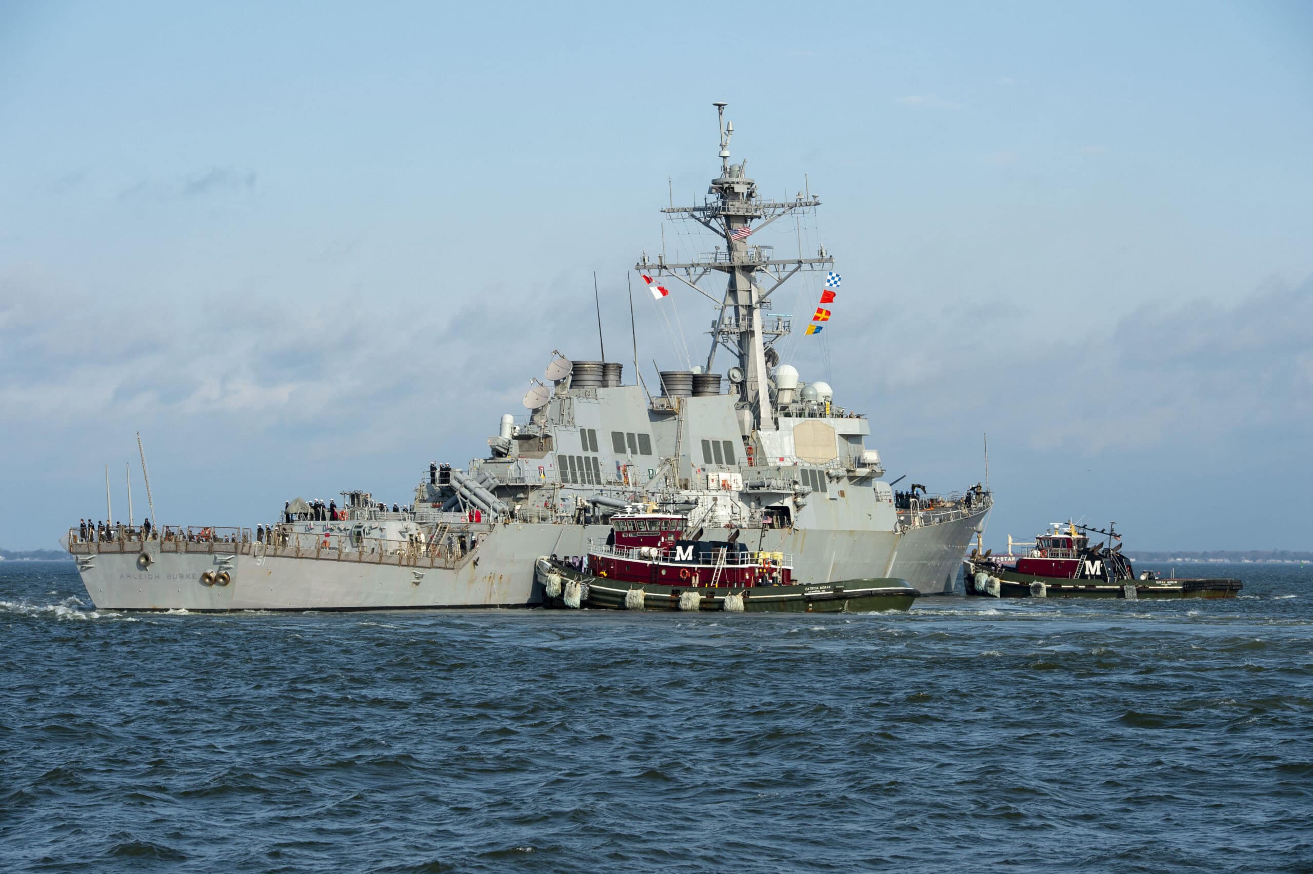 NORFOLK (Mar. 26, 2021) – A tugboat assists the guided-missile destroyer USS Arleigh Burke (DDG 51) in getting underway Mar. 26. Arleigh Burke will replace USS Donald Cook (DDG 75) as one of four forward deployed naval forces (FDNF) located in Spain. Arleigh Burke will join USS Ross (DDG 71), USS Roosevelt (DDG 80), and USS Porter (DDG 78) as the newest member of FDNF Rota. (U.S. Navy photo by Mass Communication Specialist 2nd Class Kris R. Lindstrom)