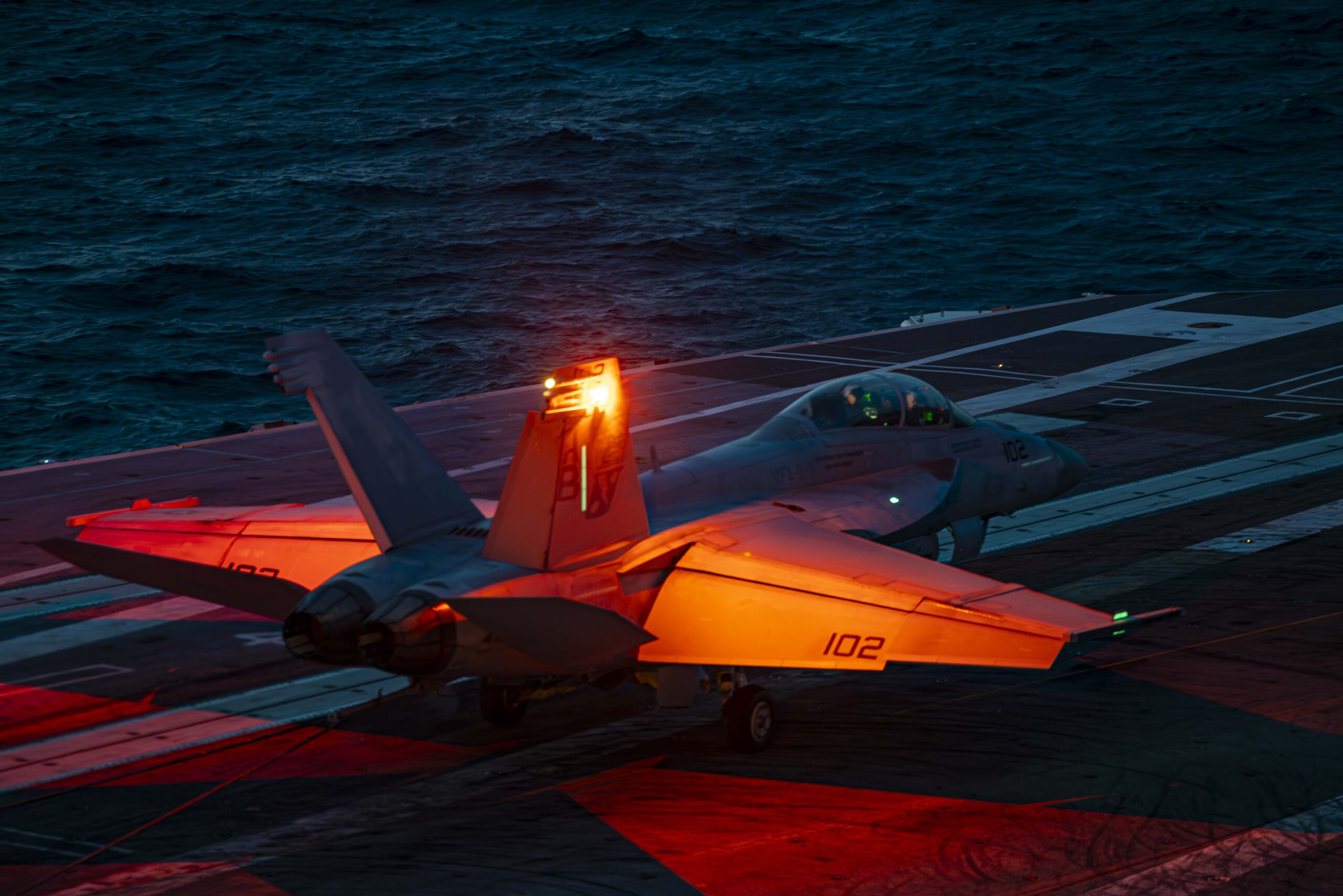 ATLANTIC OCEAN (July 28, 2024) An F/A-18F Super Hornet, attached to the “Red Rippers” of Strike Fighter Squadron (VFA) 11, lands on the flight deck of the Nimitz-class aircraft carrier USS Harry S. Truman (CVN 75), July 28. The Harry S. Truman Carrier Strike Group is underway in the Atlantic Ocean completing integrated naval warfighting training. Composite Unit Training Exercises are an intense, multi-week exercise designed to fully integrate a carrier strike group as a cohesive, multi-mission fighting force, to assess their ability to carry out sustained combat operations from the sea, and drive future warfighting development. (U.S. Navy Photo by Mass Communication Specialist 3rd Class Logan Nystrand)