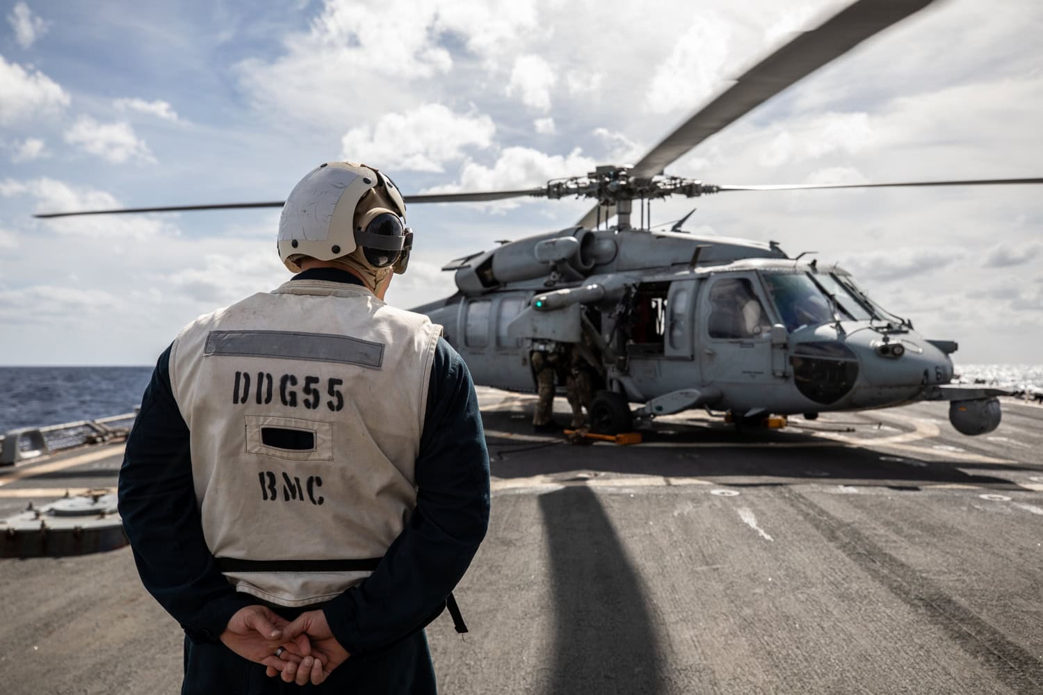 U.S. CENTRAL COMMAND AREA OF RESPONSIBILITY (Dec. 30, 2024) A U.S. Navy Boatswain’s Mate oversees the landing of an MH-60S Sea Hawk aboard the Arleigh Burke-class guided-missile destroyer USS Stout (DDG 55) in the U.S. Central Command area of responsibility. (Official U.S. Navy photo)