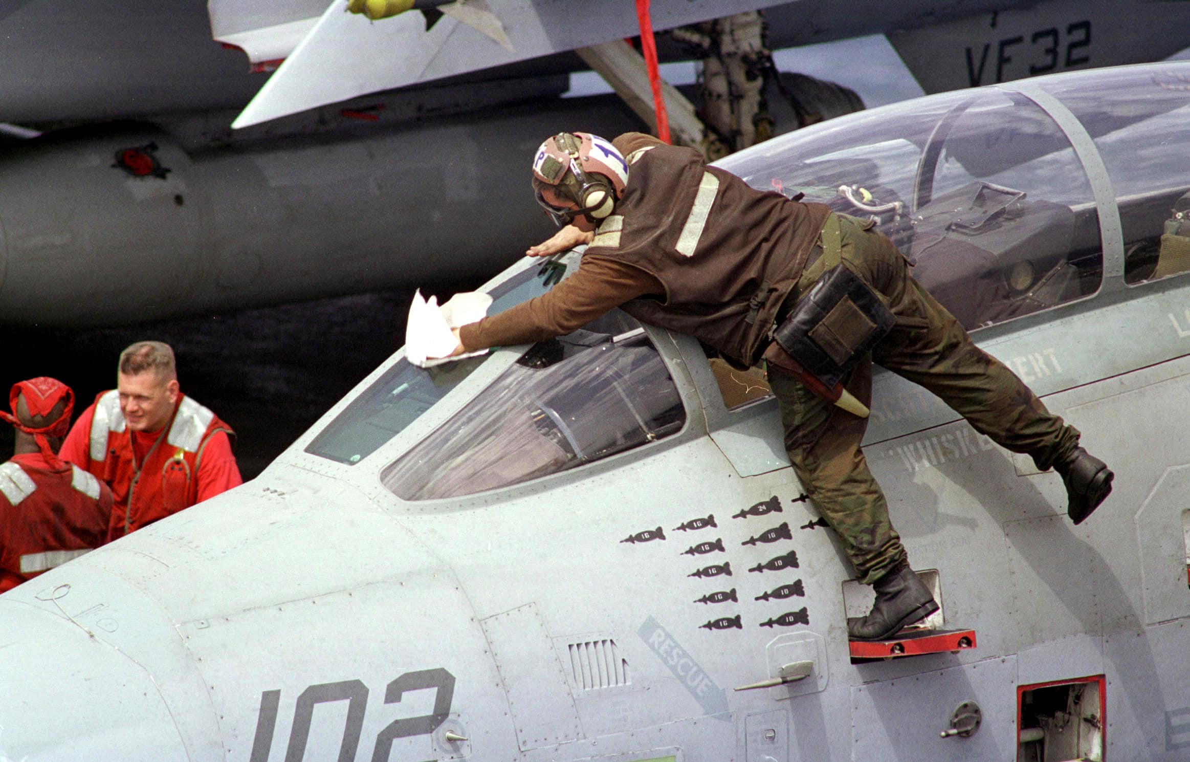 The plane captain of an F-14B Tomcat wipes down the canopy prior to flight operations from the flight deck of the USS Enterprise (CVN 65) on April 8, 1999. Enterprise and its embarked Carrier Air Wing 3 are on station in the Persian Gulf in support of Operation Southern Watch, which is the U.S. and coalition enforcement of the no-fly-zone over Southern Iraq.
