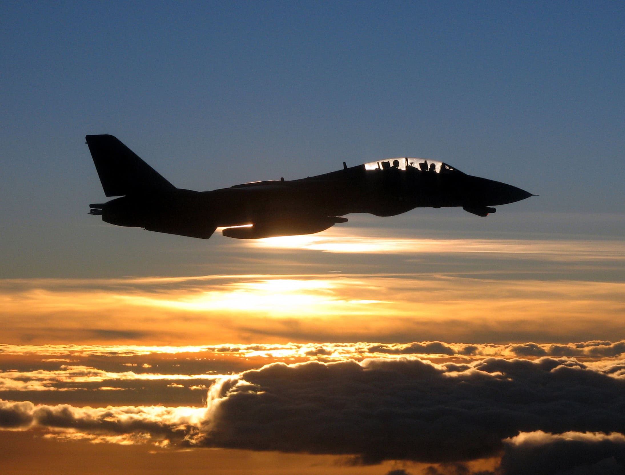 A Navy F-14D Tomcat is silhouetted against the sun as it flies a mission over the Persian Gulf on Dec. 4, 2005. The Tomcat and its crew are assigned to Fighter Squadron 213 and are operating off of the aircraft carrier USS Theodore Roosevelt (CVN 71). Roosevelt and its embarked Carrier Air Wing 8 are conducting maritime security operations in the Persian Gulf.
