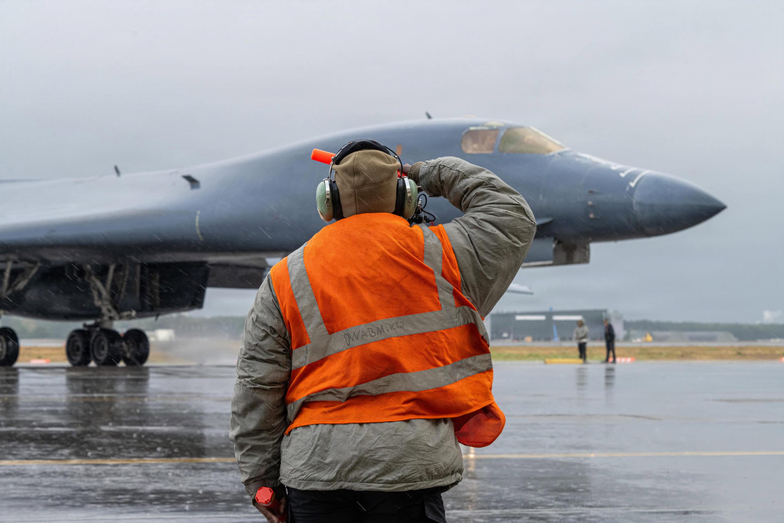 U.S. Air Force Airman 1st Class Jamiah Bradley, 9th Expeditionary Bomb Squadron crew chief, salutes a B-1B Lancer assigned to the 9th EBS while on a bomber task force deployment at Misawa Air Base, Japan, Oct. 28, 2025. The BTF deployment to Misawa  demonstrates interoperability and bolsters Pacific Air Forces’ ability to support a free and open Indo-Pacific in coordination with the Government of Japan. (U.S. Air Force photo by Airman 1st Class Adrien Tran)
