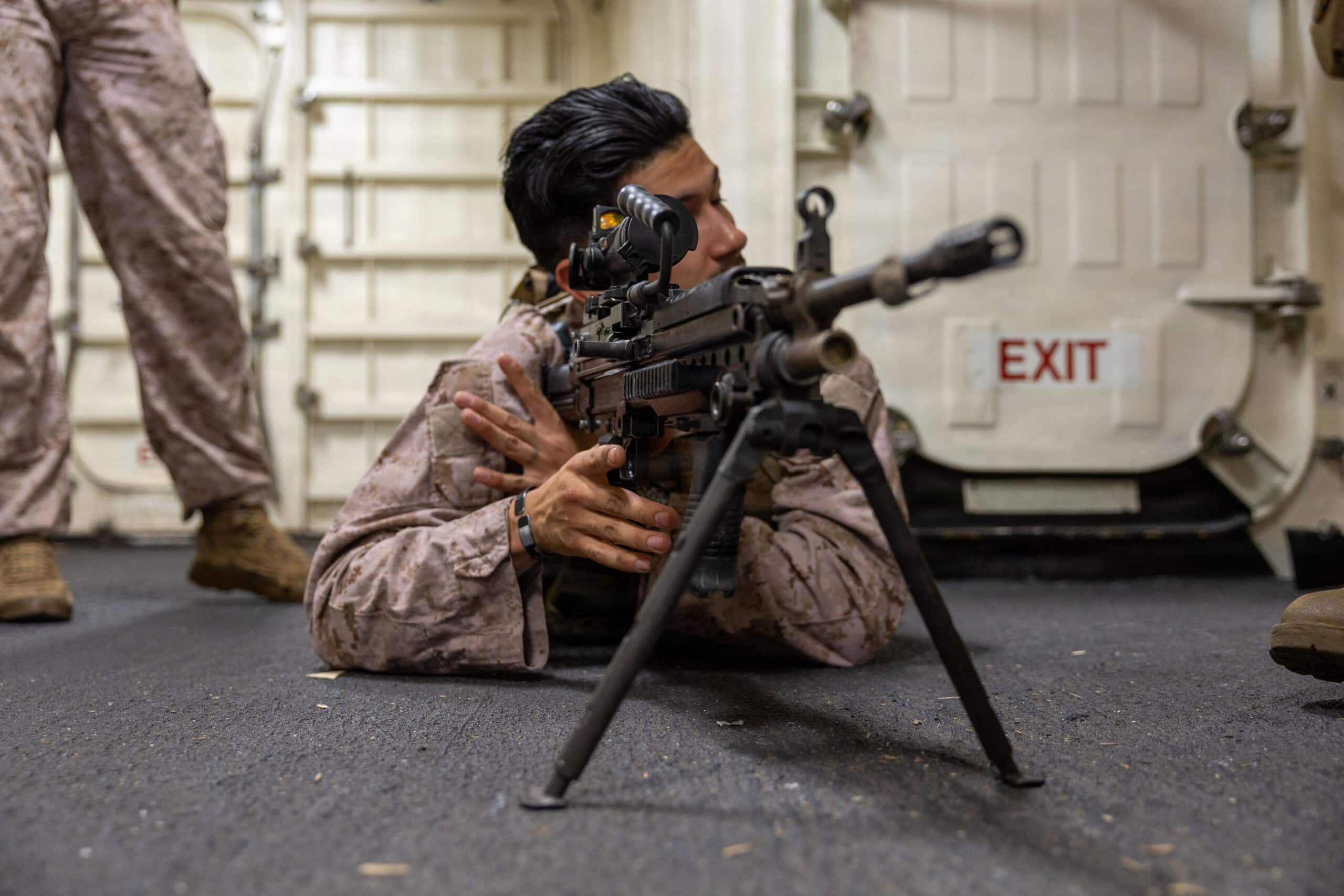 PACIFIC OCEAN (March 23, 2026) U.S. Marine Corps Sgt. Osvaldo Ochoagomez, an infantry squad leader with Lima Company, Battalion Landing Team 3/5, 11th Marine Expeditionary Unit, demonstrates how to use an M27 infantry automatic rifle aboard San Antonio-class amphibious transport dock ship USS Portland (LPD 27), March 23, 2026. Portland, part of the Boxer Amphibious Ready Group, is underway with the 11th Marine Expeditionary Unit in the U.S. 3rd Fleet area of operations demonstrating the U.S. Navy’s long-term commitment to a free and open Indo-Pacific. (U.S. Navy photo by Mass Communication Specialist 2nd Class Sheryssa Dodard)