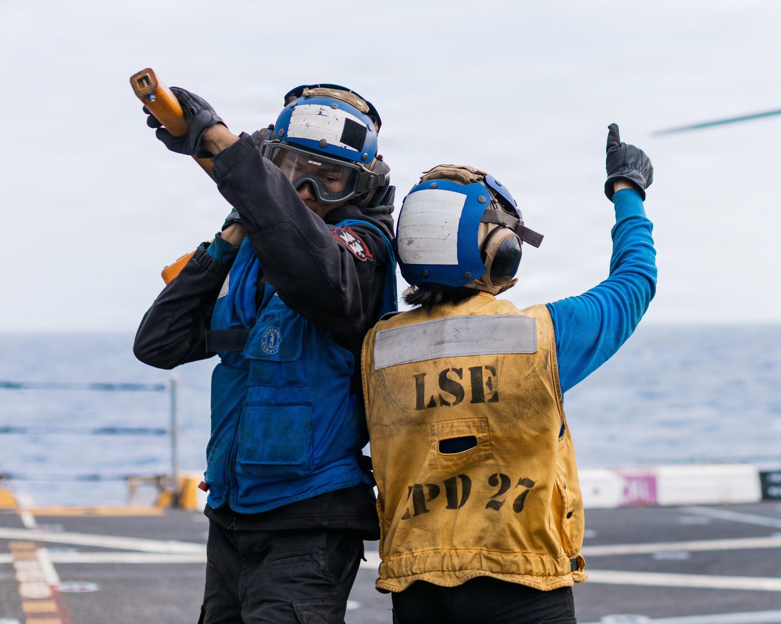 U.S. Navy Aviation Boatswain’s Mate Airmen Gregory Byias, left, and Victoria Deporto, both assigned to San Antonio-class amphibious transport dock ship USS Portland (LPD 27), participate in flight operations in the Pacific Ocean, April 10, 2026. The 11th MEU, embarked aboard the Boxer Amphibious Ready Group, is a persistent, combat credible force contributing to deterrence and crisis response in the U.S. 7th Fleet area of operations. U.S. 7th Fleet, the U.S. Navy’s largest forward-deployed numbered fleet, routinely interacts and operates with allies and partners to preserve a free and open Indo-Pacific. (U.S. Marine Corps photo by Lance Cpl. Luke Rodriguez)