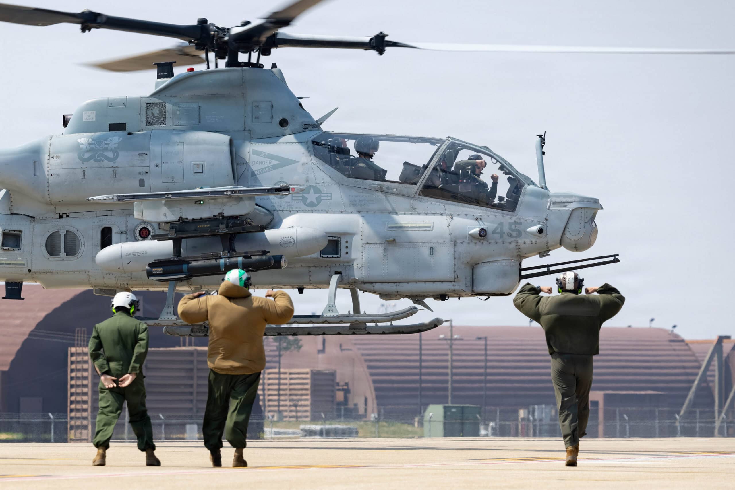 U.S. Marines with Marine Light Attack Helicopter Squadron 369, Marine Aircraft Group 36, 1st Marine Aircraft Wing signal to a departing AH-1Z Viper after Korean Marine Exchange Program 26.1 on Osan Air Base, Gyeonggi-do, South Korea after Korean Marine Exchange Program 26.1, April 2, 2026. KMEP is a semi-annual exercise that provides iterative opportunities for Republic of Korea Marine Corps and U.S. Marine Corps units to train together, improving their combined capabilities to deter threats and maintain peace on the Korean Peninsula. (U.S. Marine Corps photo by Lance Cpl. Carlos Paz-Sosa)