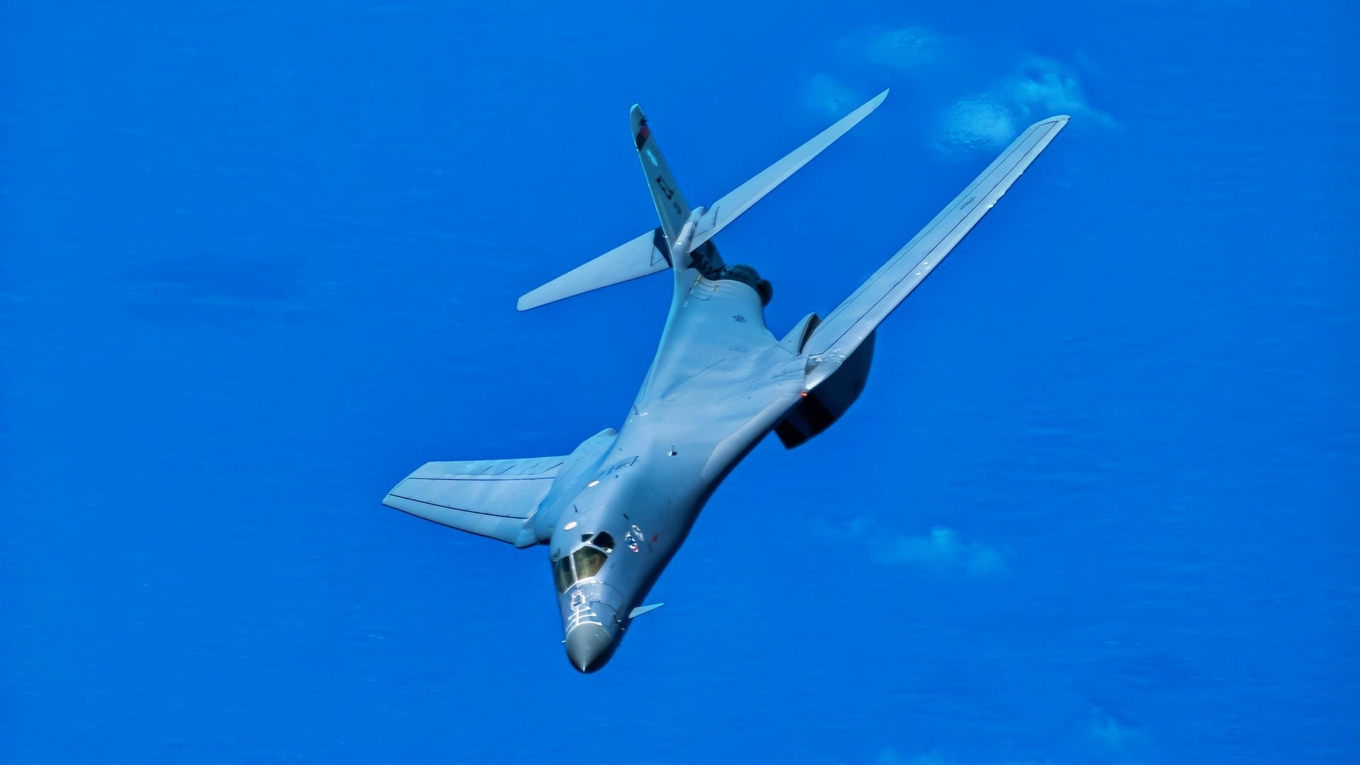 A U.S. Air Force B-1B Lancer attached to the 34th Bomb Squadron, Ellsworth Air Force Base, South Dakota, banks right with the wings in the swept position over the Pacific Ocean after taking off from Anderson Air Force Base, Guam, June 12, 2022. Bomber missions contribute to joint force lethality and deter aggression in the Indo-Pacific by demonstrating United States Air Force ability to operate anywhere in the world at any time in support of the National Defense Strategy. (U.S. Air Force Photo by Technical Sgt. Chris Hibben)