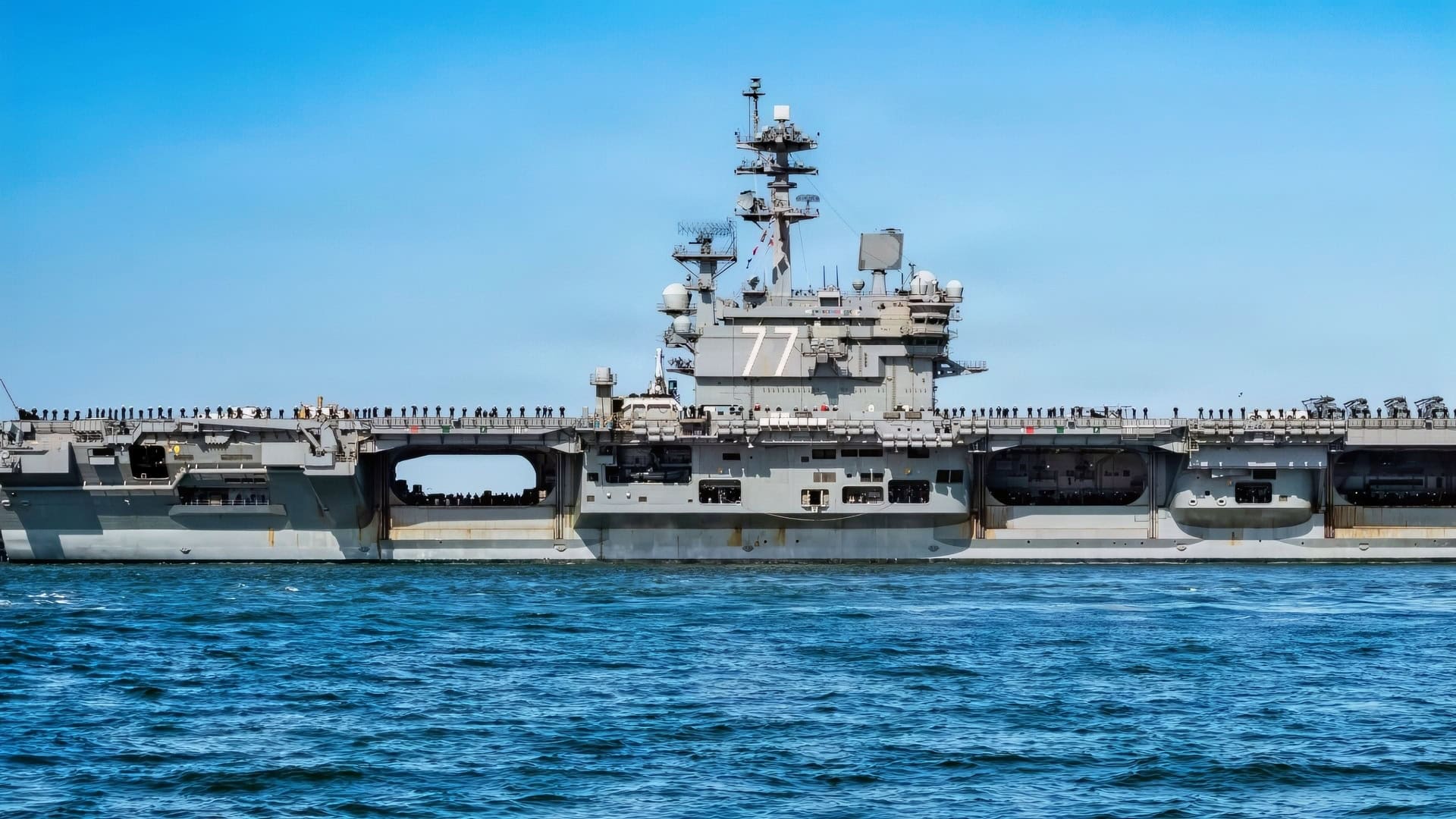 NAVAL STATION NORFOLK (March 31, 2026) The Nimitz-class aircraft carrier USS George H.W. Bush (CVN 77), the flagship of the George H.W. Bush Carrier Strike Group, departs Naval Station Norfolk to begin operations in support of its scheduled deployment, March 31, 2026. More than 5,000 personnel are assigned to the George H.W. Bush Carrier Strike Group. The George H.W. Bush Carrier Strike Group provides combatant commanders and America’s civilian leaders increased capacity to underpin American security and economic prosperity, deter adversaries, and project power on a global scale through sustained operations at sea. (U.S. Navy photo by Mass Communication Specialist 2nd Class Derek Cole)