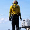 Aviation Boatswain’s Mate (Aircraft Handling) 2nd Class Jawan George transits the flight deck of the world's largest aircraft carrier, USS Gerald R. Ford (CVN 78), while underway in the Mediterranean Sea, April 6, 2026. Gerald R. Ford is on a scheduled deployment in the U.S. 6th Fleet area of operations to support the warfighting effectiveness, lethality and readiness of U.S. Naval Forces Europe-Africa, and defend U.S., Allied and partner interests in the region. (U.S. Navy photo by Mass Communication Specialist Seaman Paige Brown)