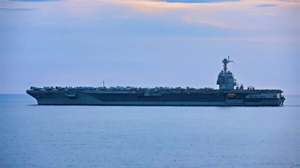 (July 4, 2023) The crew of Ford Class Aircraft Carrier USS Gerald R. Ford (CVN 78) stand on the flight deck to watch a Fourth of July gun shoot from Arleigh Burke-class guided-missile destroyer USS Ramage (DDG 61) (not pictured), July 4, 2023. Ramage is part of the Gerald R. Ford Carrier Strike Group and is on a scheduled deployment in the U.S. Naval Forces Europe area of operations, employed by the U.S. Sixth Fleet to defend U.S., allied, and partner interests. (U.S. Navy photo by Mass Communication Specialist 3rd Class Adriones Johnson)