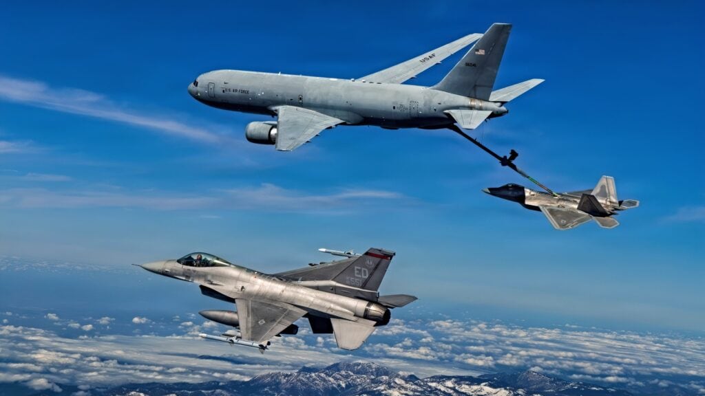 A KC-46 Pegasus assigned to the 418th Flight Test Squadron, Global Reach Combined Test Force, refuels an F-22 Raptor assigned to the 411th Flight Test Squadron, Air Dominance Combined Test Force while an F-16 assigned to the 416th Flight Test Squadron, Airpower Foundations Combined Test Force, awaits a turn over the Mojave Desert on March 3, 2026. Partnerships between the Combined Test Forces at Edwards helps expedite critical capability for the warfighter by leveraging multiple program portfolios in tandem. In this scenario, the F-16 aircraft was operating as a target for key F-22 Raptor test points while the KC-46 was able to collect additional data for aerial refueling efforts. (Courtesy photo)