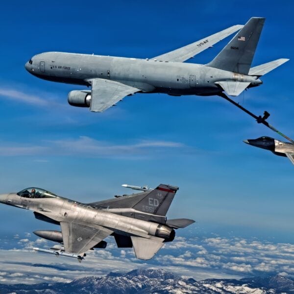 A KC-46 Pegasus assigned to the 418th Flight Test Squadron, Global Reach Combined Test Force, refuels an F-22 Raptor assigned to the 411th Flight Test Squadron, Air Dominance Combined Test Force while an F-16 assigned to the 416th Flight Test Squadron, Airpower Foundations Combined Test Force, awaits a turn over the Mojave Desert on March 3, 2026. Partnerships between the Combined Test Forces at Edwards helps expedite critical capability for the warfighter by leveraging multiple program portfolios in tandem. In this scenario, the F-16 aircraft was operating as a target for key F-22 Raptor test points while the KC-46 was able to collect additional data for aerial refueling efforts. (Courtesy photo)