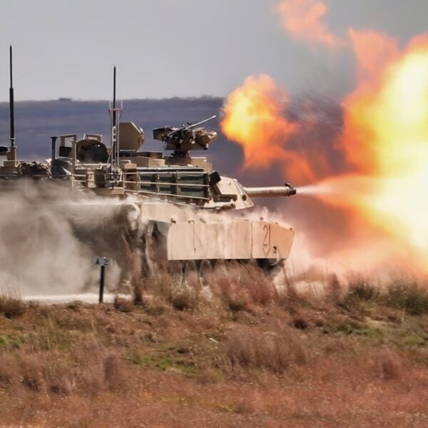 An M1A1 Abrams tank operated by Soldiers with the 2nd Battalion, 70th Armored Regiment, 2nd Armored Brigade Combat Team, 1st Infantry Division, fires while moving at the Douthit Gunnery Complex on Fort Riley, Kansas, Oct. 19, 2022. The tank crew was conducting gunnery for qualification. (U.S. Army photo by Sgt. Jared Simmons)