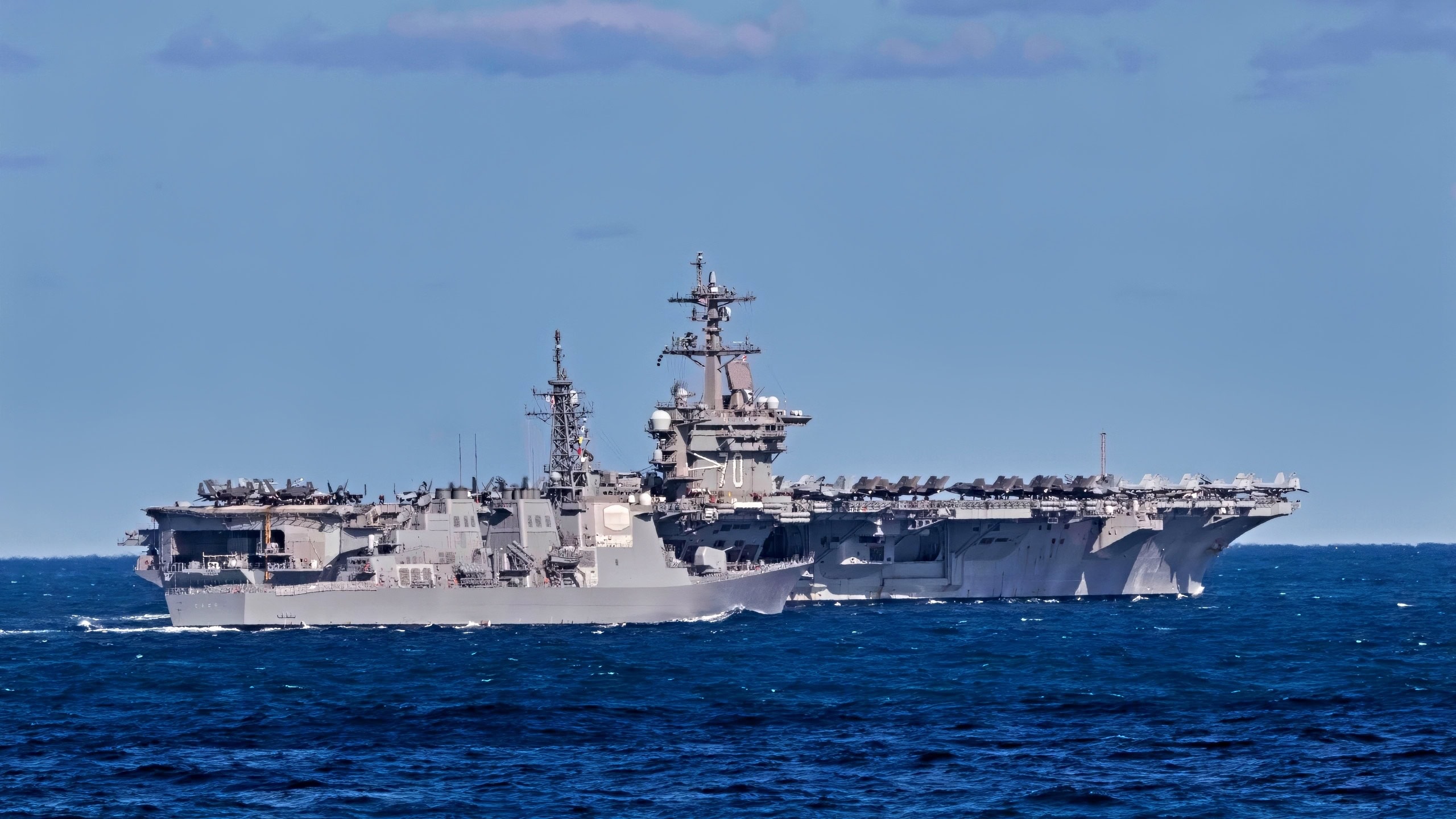 A 100,000-Ton Aircraft Carrier Drag-Raced a Cruiser in the Middle of the Ocean. It Was Only Using 3 of 4 Engines. It Almost Won