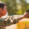 U.S. Army Sgt. Gengyang Jiang, assigned to Headquarters and Headquarters Company, 1st Battalion, 18th Infantry Regiment, 1st Infantry Division, practiced aiming a SIG Sauer M17 pistol for one of the International Sniper competition events at Fort Benning, Ga., April 9, 2026. The International Sniper Competition tests elite teams in a rigorous gauntlet of events including long-range marksmanship, stealth movement, and reconnaissance and reporting ability. (U.S. Army photo by Sgt. Chase Murray)