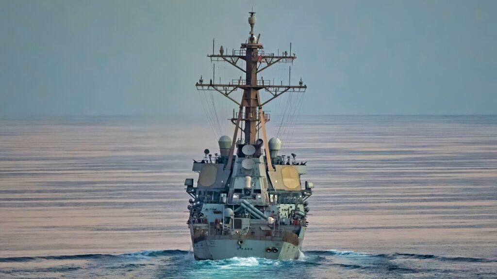 STRAIT OF HORMUZ (Nov. 12, 2021) Guided-missile destroyer USS O’Kane (DDG 77) performs a Strait of Hormuz transit with the amphibious assault ship USS Essex (LHD 2), Nov. 12. Essex and the 11th Marine Expeditionary Unit are deployed to the U.S. 5th Fleet area of operations in support of naval operations to ensure maritime stability and security in the Central Region, connecting the Mediterranean and the Pacific through the western Indian Ocean and three strategic choke points. (U.S. Navy photo by Mass Communication Specialist 1st Class Joe Rolfe)