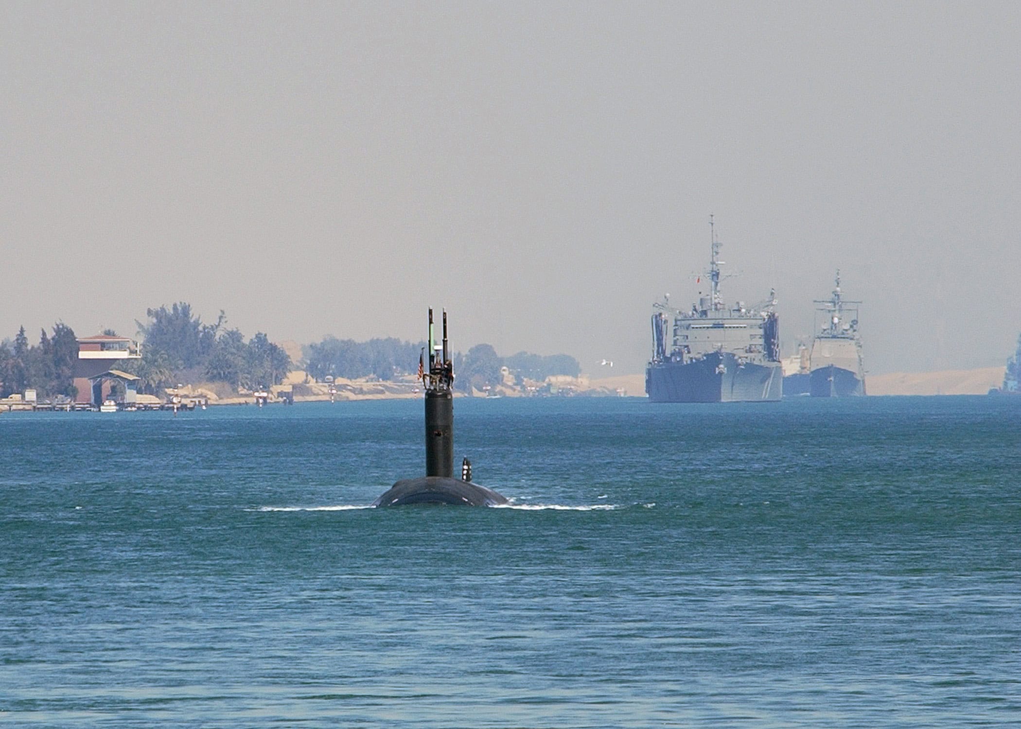 020304-N-6492H-601
Suez Canal (Mar. 4, 2002) The Los Angeles class attack submarine, USS Boise (SSN 764) leads the fast combat support ship, USS Seattle (AOE 3) and the guided missile cruiser, USS Hue City (CG 66) as the ships of USS John F. Kennedy (CV 67) Battle Group transit the Suez Canal. The Kennedy battle group is arriving to relieve USS Theodore Roosevelt (CVN 71) to conduct missions in support of Operation Enduring Freedom. U.S. Navy photo by PhotographerÕs Mate 1st Class Jim Hampshire. (RELEASED)