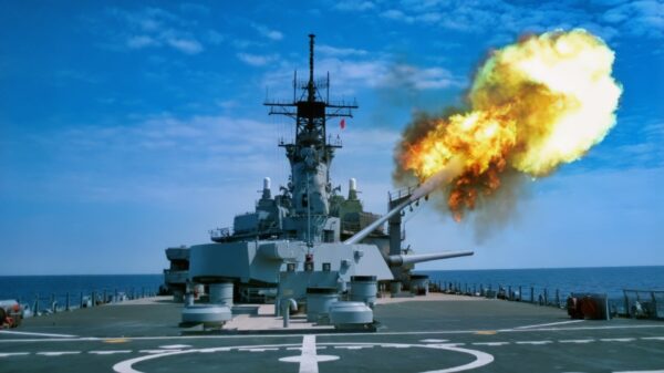 A round is fired from the No. 3 Mark 7 16-inch/50 caliber gun turret during gunnery exercises aboard the battleship USS IOWA (BB 61). The barrel is elevated to the 03 level to test the effects of 16-inch gun overpressure on the Tomahawk armored box launcher located on that level.