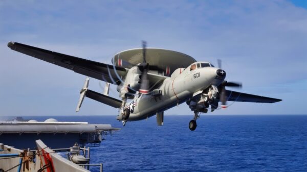 ABOARD USS KITTY HAWK (CV 63) AT SEA (May 22, 2004) -- An E-2C Hawkeye assigned to Airborne Early Warning Squadron (VAW) 115 "Liberty Bells" banks after being launched from USS Kitty Hawk (CV 63) following the ship's annual spring cruise. The E-2C is all weather, carrier-based tactical warning/control system aircraft, providing airborne early warning and control functions for the strike group. Currently under way in the 7th Fleet area of responsibility (AOR), Kitty Hawk demonstrates power projection and sea control as the world's only permanently forward-deployed aircraft carrier, operating from Yokosuka, Japan.