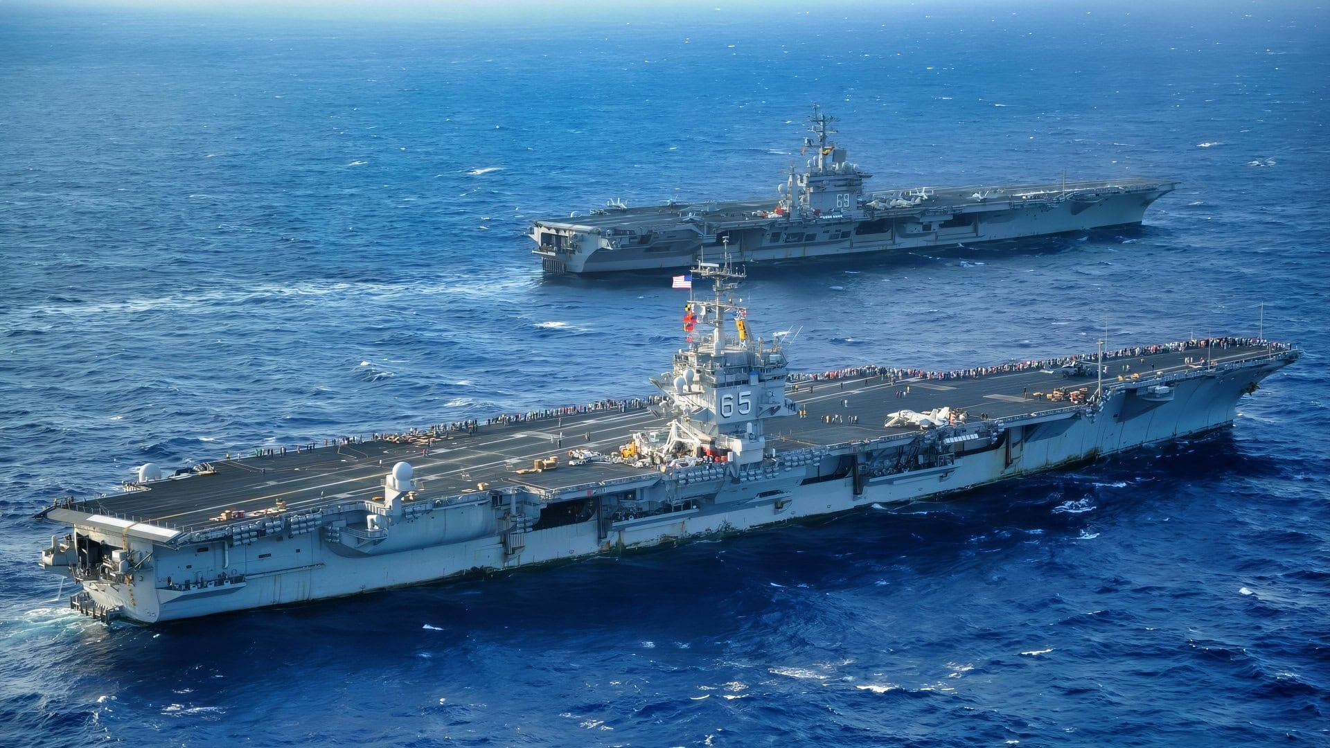 ATLANTIC OCEAN (July 14, 2011) The aircraft carriers USS Enterprise (CVN 65) and USS Dwight D. Eisenhower (CVN 69) pass as Enterprise returns to homeport after completing a six-month deployment to the U.S. 5th and 6t Fleet areas of responsibility. Dwight D. Eisenhower is underway conducting carrier qualifications. (U.S. Navy photo by Mass Communication Specialist 3rd Class Shonna L. Cunningham/Released)