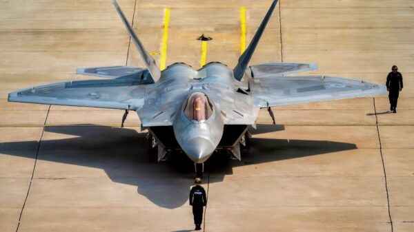 U.S. Air Force Staff Sgt. Robin Wharton, multi-capable Airman, left, and Tech. Sgt. Jarred Cool, a dedicated crew chief, both assigned to the F-22 Raptor Demonstration Team, perform the team's silent ground show prior to an aerial demonstration at the Cold Lake Airshow in Cold Lake, Alberta, Canada, July 18, 2026. The airshow brought U.S. and Canadian performers and communities together, highlighting the strong partnership between two nations united by a shared passion for aviation. This demonstration highlights the unique thrust-vectoring capabilities of the F-22, allowing it to achieve extreme agility unmatched by other fighter aircraft. (U.S. Air Force photo by Staff Sgt. Lauren Diaz)