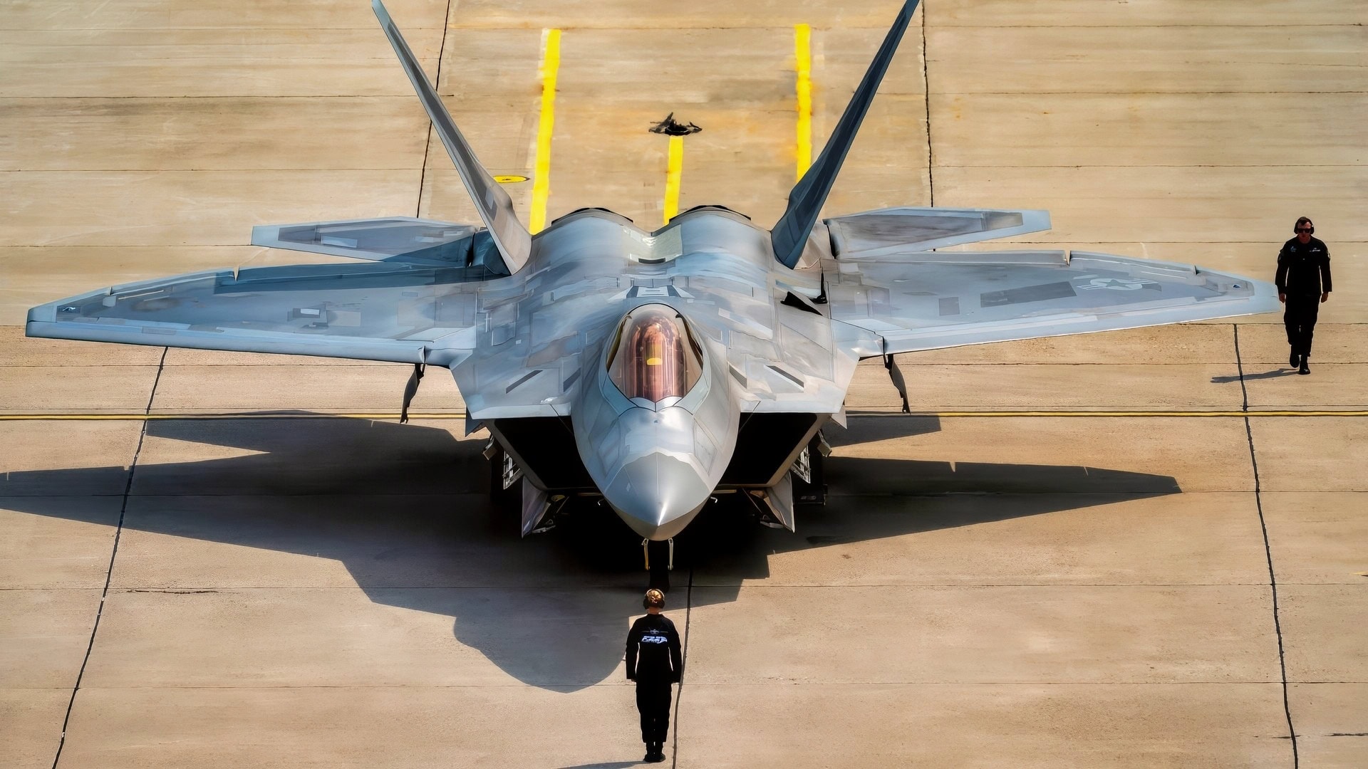 U.S. Air Force Staff Sgt. Robin Wharton, multi-capable Airman, left, and Tech. Sgt. Jarred Cool, a dedicated crew chief, both assigned to the F-22 Raptor Demonstration Team, perform the team's silent ground show prior to an aerial demonstration at the Cold Lake Airshow in Cold Lake, Alberta, Canada, July 18, 2026. The airshow brought U.S. and Canadian performers and communities together, highlighting the strong partnership between two nations united by a shared passion for aviation. This demonstration highlights the unique thrust-vectoring capabilities of the F-22, allowing it to achieve extreme agility unmatched by other fighter aircraft. (U.S. Air Force photo by Staff Sgt. Lauren Diaz)
