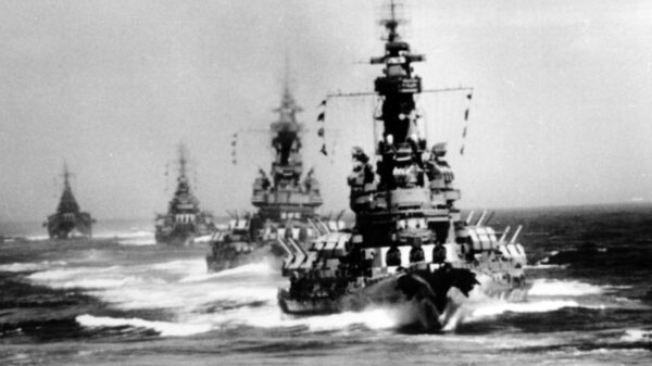 Battleships and heavy cruisers steam in column off Kamaishi, at the time they bombarded the iron works there, as seen from USS South Dakota (BB-57). USS Indiana (BB-58) is the nearest ship, followed by USS Massachusetts (BB-59). Cruisers Chicago (CA-136) and Quincy (CA-71) bring up the rear. Official U.S. Navy Photograph, now in the collections of the National Archives.