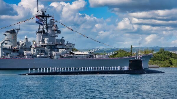 PEARL HARBOR, Hawaii (January 26, 2018) The crew of the Virginia-class fast-attack submarine USS Missouri (SSN 780) render honors to the Battleship Missouri Memorial following a homeport change from Groton, Connecticut. (U.S. Navy photo by Mass Communication Specialist 2nd Class Michael H. Lee/ Released)