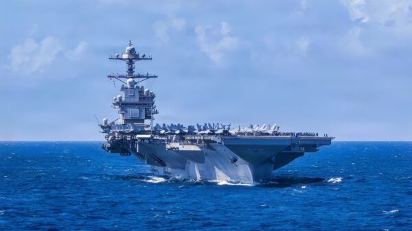 U.S. Navy Carrier Air Wing 8 aircraft fly in formation over the world’s largest aircraft carrier, Ford-class aircraft carrier USS Gerald R. Ford (CVN 78), during Carrier Air Wing 8’s aerial change of command ceremony while underway in the Caribbean Sea, Jan. 19, 2026. U.S. military forces are deployed to the Caribbean in support of the U.S. Southern Command mission, Department of War-directed operations, and the president’s priorities to disrupt illicit drug trafficking and protect the homeland. (U.S. Navy photo)