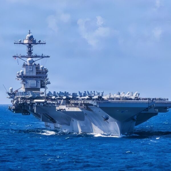 U.S. Navy Carrier Air Wing 8 aircraft fly in formation over the world’s largest aircraft carrier, Ford-class aircraft carrier USS Gerald R. Ford (CVN 78), during Carrier Air Wing 8’s aerial change of command ceremony while underway in the Caribbean Sea, Jan. 19, 2026. U.S. military forces are deployed to the Caribbean in support of the U.S. Southern Command mission, Department of War-directed operations, and the president’s priorities to disrupt illicit drug trafficking and protect the homeland. (U.S. Navy photo)