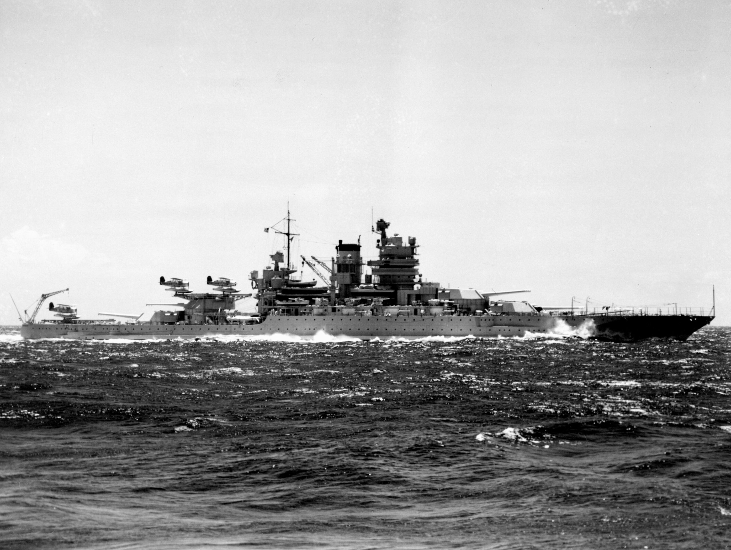 The U.S. Navy battleship USS Mississippi (BB-41) operating at sea during the later 1930s. She has three Curtiss SOC Seagull aircraft on her catapults.