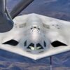 A B-21 Raider rejoins with a KC-135 Stratotanker. The B-21 program exemplifies the Department of the Air Force's warfighting-focused acquisition mindset, leveraging digital engineering and modern production to deliver a mature, highly capable system at speed. The B-21's efficiency and flexibility will provide a survivable, unpredictable deterrent force, forming the backbone of America’s future bomber force. (U.S. Air Force photo by Todd Schannuth, image altered for security)