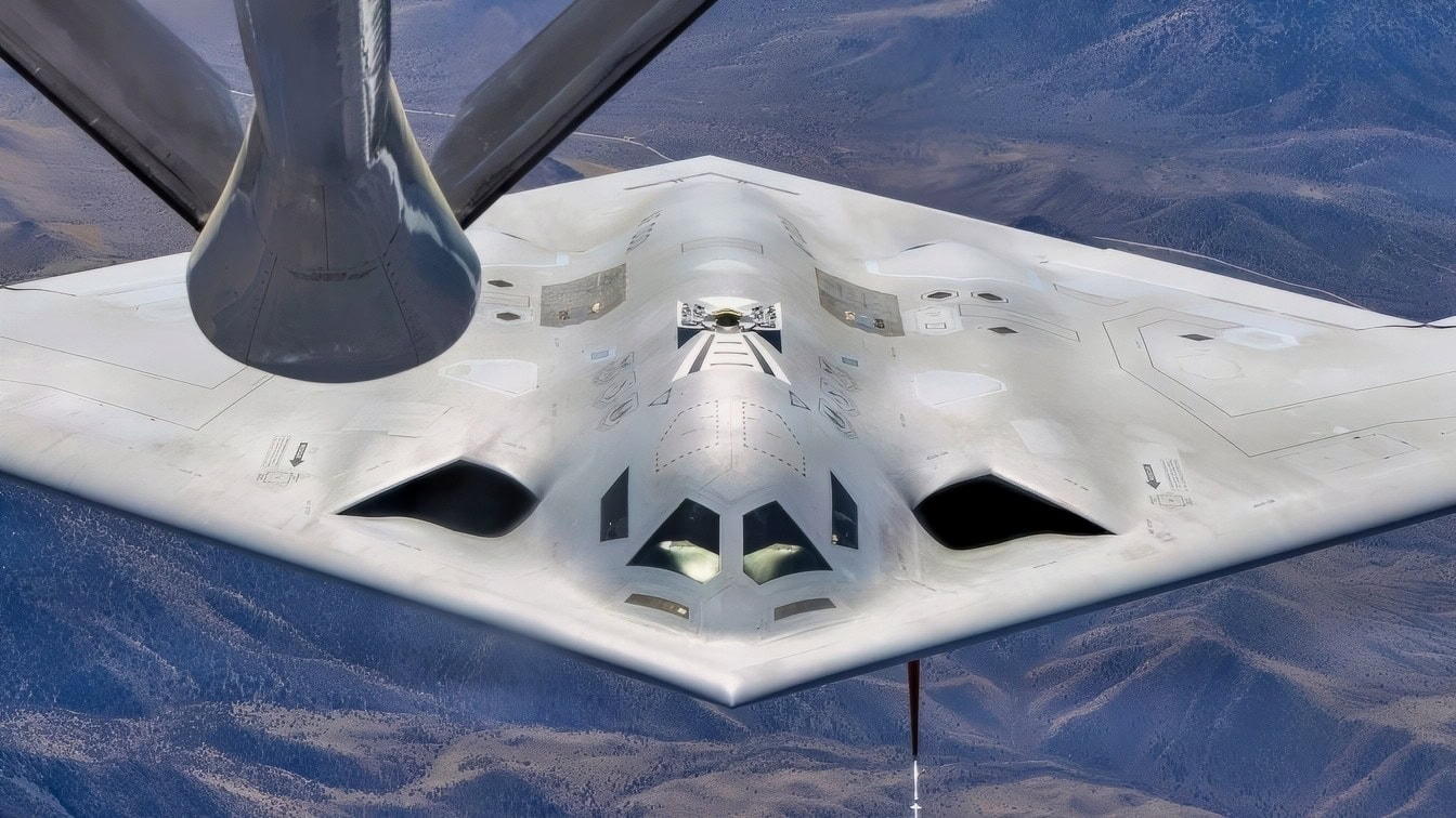A B-21 Raider rejoins with a KC-135 Stratotanker. The B-21 program exemplifies the Department of the Air Force's warfighting-focused acquisition mindset, leveraging digital engineering and modern production to deliver a mature, highly capable system at speed. The B-21's efficiency and flexibility will provide a survivable, unpredictable deterrent force, forming the backbone of America’s future bomber force. (U.S. Air Force photo by Todd Schannuth, image altered for security)
