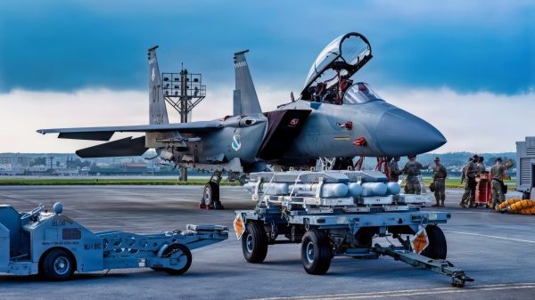 U.S. Air Force Airmen assigned to the 67th Fighter Generation Squadron prepare to load munitions onto a U.S. Air Force F-15EX Eagle II assigned to the 85th Test and Evaluation Squadron, Eglin Air Force Base, Florida, at Kadena Air Base, Japan, July 8, 2026. Airmen from the 67th Fighter Generation Squadron trained alongside the 85th TES gaining hands-on experience loading munitions on the F-15EX Eagle II and F-15E Strike Eagle while supporting test and evaluation operations. (U.S. Air Force photo by Airman 1st Class Gracelyn Hess)