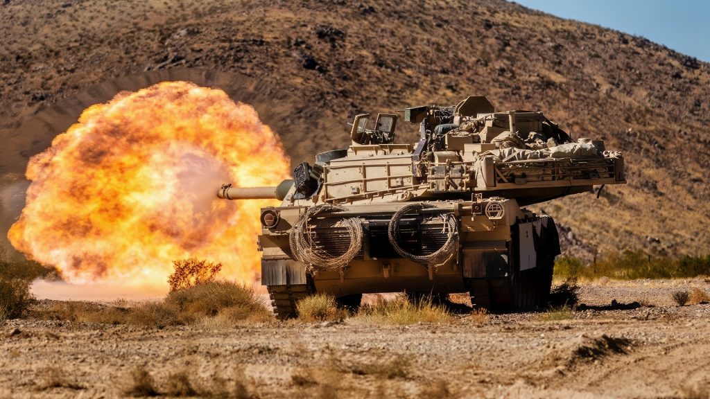 U.S. Soldiers assigned to 1st Battalion, 9th Cavalry Regiment, 2nd Armored Brigade Combat Team, 1st Cavalry Division fire an M1 Abrams main battle tank at an enemy target during Rotation 25-02 at the National Training Center, Fort Irwin, Calif., Nov. 07, 2024. Rotations at the National Training Center ensure Army Brigade Combat Teams remain versatile, responsive, and consistently available for current and future contingencies. (U.S. Army photo by Spc. Casey Auman, Operations Group, National Training Center).
