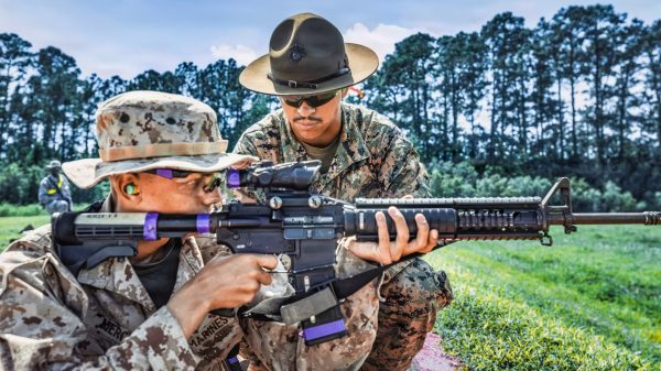 U.S. Marine Corps Cpl. Samuel Sanchez-Bermudez, a combat marksmanship coach with Range Company, Weapons and Field Training Battalion, instructs a recruit during Table One qualification on Marine Corps Recruit Depot Parris Island, S.C., Sept. 15, 2026. Recruits practice at the range to learn how to accurately fire the M16A4 Service Rifle at targets of various distances. (U.S. Marine Corps photo by Cpl. Jordy Morales)