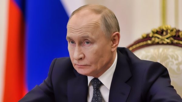 Putin Back in March of 2025 at Desk Creative Commons