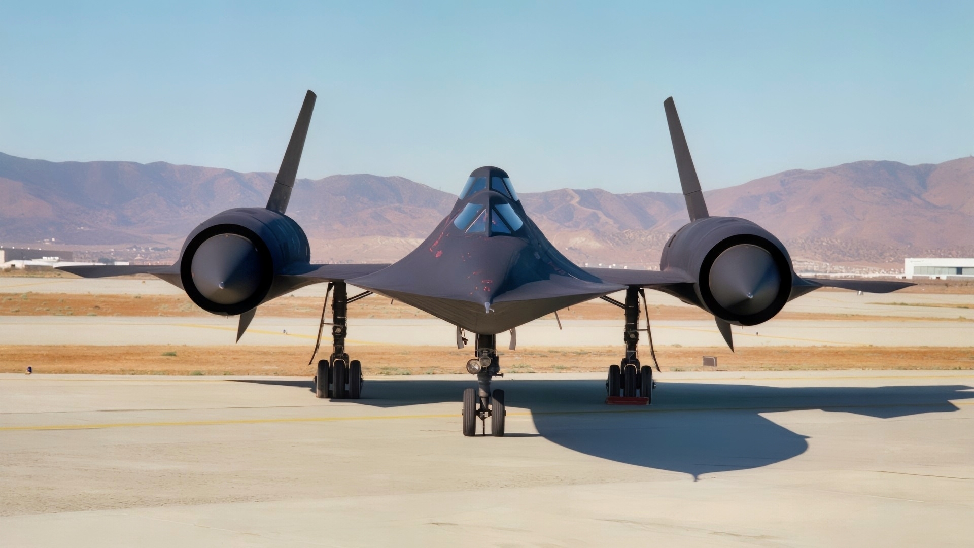 This photo shows a head-on view of NASA's SR-71B, used for pilot proficiency and training, on the ramp at the Air Force's Plant 42 in Palmdale, California, shortly before delivery to the Ames-Dryden Flight Research Facility (later, Dryden Flight Research Center) at Edwards, California. NASA operated two of these unique aircraft, an SR-71A, for high-speed, high altitude research, and this SR- 71B pilot trainer for most of the decade of the 1990s. The "B" model is special because of its raised rear cockpit, which provided a second pilot position so a trainer and an experienced pilot could both see what was going on during flights.