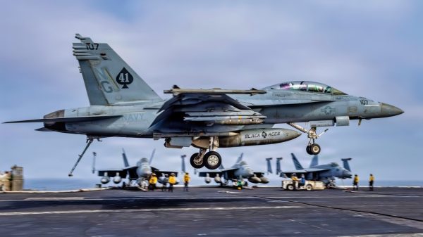 An F/A-18F Super Hornet, assigned to Strike Fighter Squadron (VFA) 41, prepares to make an arrested landing on the flight deck of Nimitz-class aircraft carrier USS Abraham Lincoln (CVN 72), Aug. 4, 2026. Abraham Lincoln is deployed to the U.S. 5th Fleet area of operations to support maritime security and stability in the Middle East. (U.S. Navy photo)