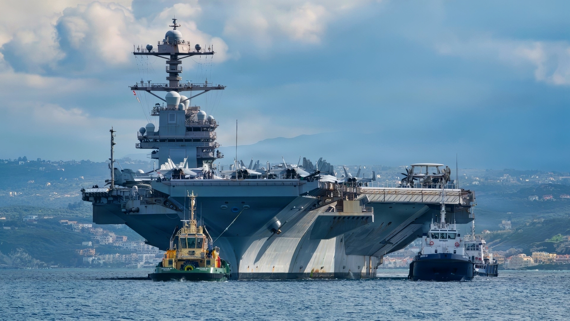 NAVAL SUPPORT ACTIVITY SOUDA BAY, Greece (Feb. 23, 2026) The world’s largest aircraft carrier, Ford-class aircraft carrier USS Gerald R. Ford (CVN 78) arrives at the NATO Marathi Pier Complex in Souda Bay, Crete, Greece, during a scheduled port visit on Feb. 23, 2026. NSA Souda Bay is an operational ashore installation that enables and supports U.S., Allied, Coalition, and partner nation forces to preserve security and stability in the European, African, and Central Command areas of responsibility. (U.S. Navy photo by Mass Communication Specialist 3rd Class Hannah Donahue)