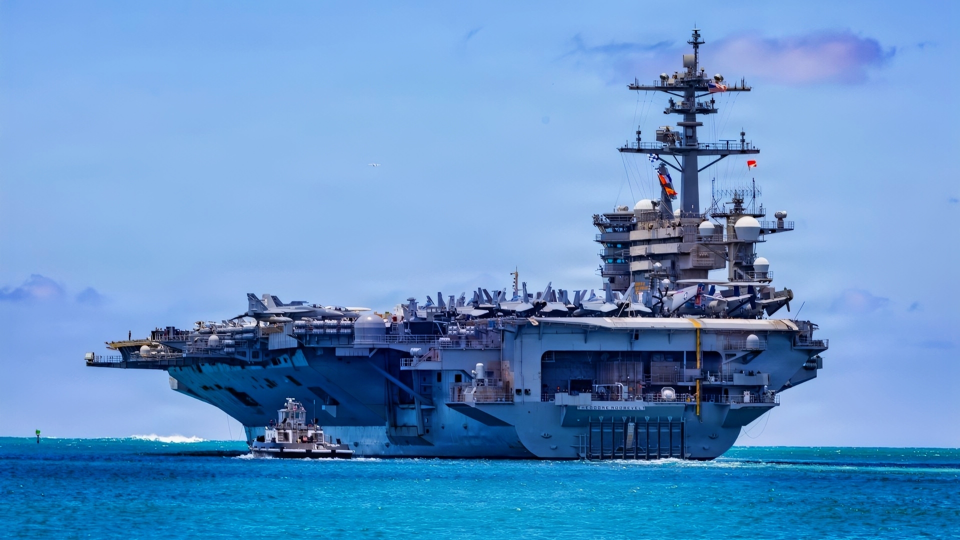 Nimitz-class aircraft carrier USS Theodore Roosevelt (CVN 71) departs Joint Base Pearl Harbor-Hickam, Hawaii, during Exercise Rim of the Pacific 2026, July 7, 2026. Thirty nations, over 30 surface ships, five submarines, 15 national land forces, more than 206 aircraft and 30,000 personnel are participating in RIMPAC in and around the Hawaiian Islands, June 24 to July 31. The world's largest international maritime exercise, RIMPAC provides a unique training opportunity while fostering and sustaining cooperative relationships among participants critical to ensuring the safety of sea lanes and security on the world's oceans. RIMPAC 2026 is the 30th exercise in the series that began in 1971. (U.S. Navy photo by Mass Communications Specialist First Class Luke McCall)
