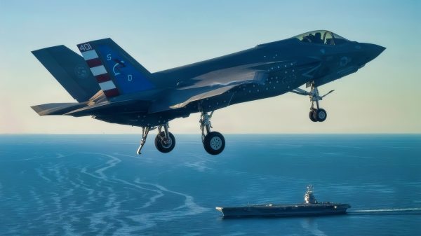 An F-35 test pilot from Air Test and Evaluation Squadron Two Three (VX-23), Naval Air Warfare Center Aircraft Division (NAWCAD), flies an F-35C Lightning II fighter aircraft to the PCU John F. Kennedy (CVN 79) in the Western Atlantic Oct. 13, 2026. This is the first time an F-35C has landed on a Ford-class aircraft carrier. A Patuxent River F-35 Integrated Test Force (ITF) team detached to the ship is conducting Aircraft Compatibility Testing (ACT) with the specially instrumented carrier variant of the stealth jet. ACT assesses the operational capabilities of the ship's aircraft launch and recovery equipment with U.S. Navy aircraft.