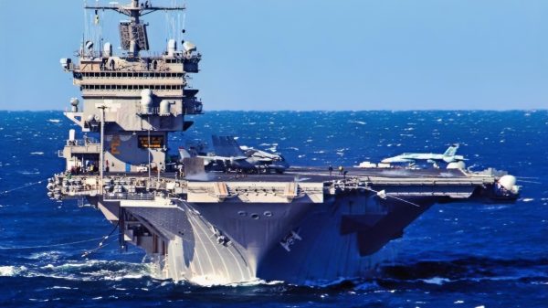 Atlantic Ocean (Feb. 6, 2006)-- The Guided-Missle Destroyer USS MCFAUL (DDG 74) steams alongside the nuclear-powered aircraft carrier USS ENTERPRISE (CVN 65) for a refueling at sea. ENTERPRISE is currently underway in the Atlantic Ocean conducting carrier qualifications. Official US Navy photo by Photographer's Mate 3rd Class Josh Kinter.